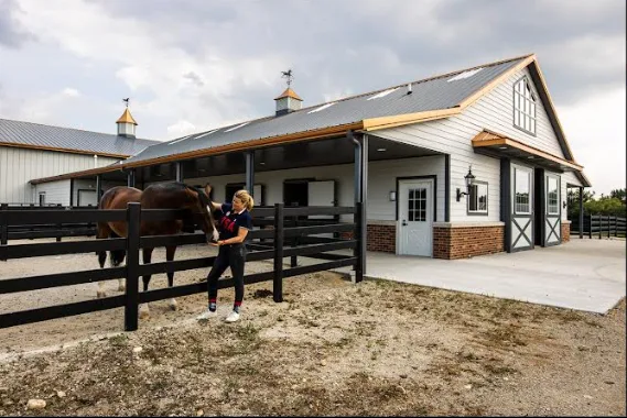 Steel equestrian facility with covered barn and horse paddock
